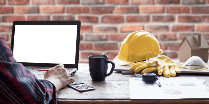 general-contractor-loans-everything-you-need-to-know-about-getting-loan-as-contractor general contractor sitting at a desk working at a computer researching small business funding