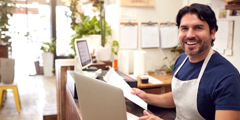 what-is-a-merchant-cash-advance-used-for male small business owner doing finances and planning growth