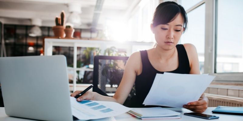 what-you-need-to-know-short-long-term-small-business-funding business woman reviewing files at desk